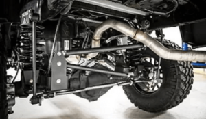 image of underneath a brand new lift kit showing exhaust on offroad vehicle at Accelerate Auto Repair in Rowlett Tx