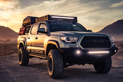 Let’s Get You Set Up with Your Perfect Lift Kit, Rim, and Tire Performance Upgrade Packages with Accelerate Auto Repair in Rowlett TX.; image of Toyota Tundra with lift kit, rim and tires on it in desert