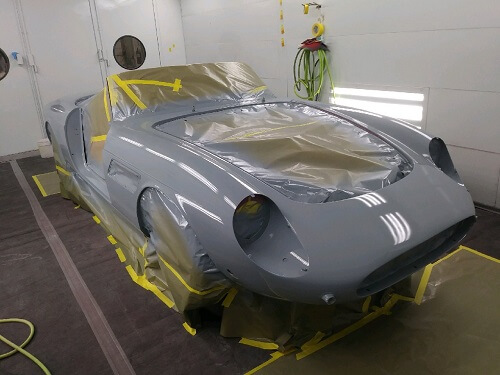 Choosing the Best Paint & Custom Body Work Shop | Accelerate Auto Repair in Rowlett TX. Image of a gray car body undergoing painting and custom body work.