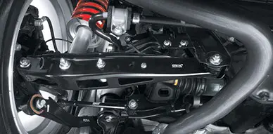 underneath a vehicle showing upgraded suspension at Accelerate Auto Repair in Rowlett Tx