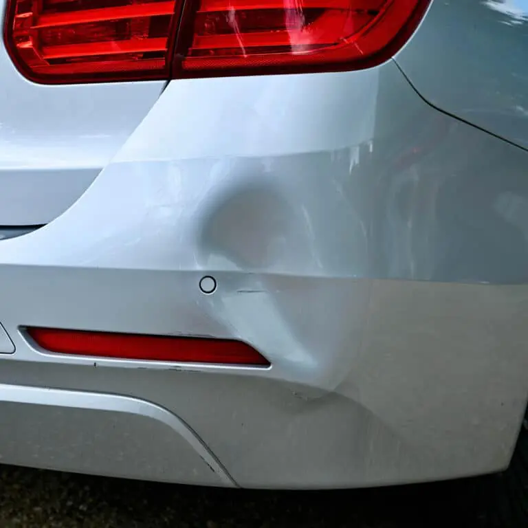 Accelerate Auto Repair and Collision in Rowlett, TX, silver sedan with dent in bumper getting repaired, paintless dent repair in Rowlett, TX