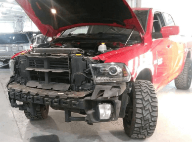 a red ford pickup truck with hood raised and bumper removed that came into Accelerate Auto in Rowlett Tx for collision service