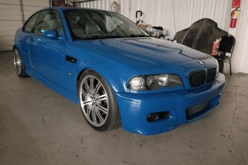 Where Can I Find Affordable European Auto Repair in Rowlett, TX? with Accelerate Auto Repair. Image of blue BMW in shop bay area for repairs