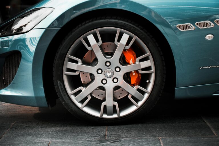 Maserati wheel with a drilled brake rotor and orange brake caliper