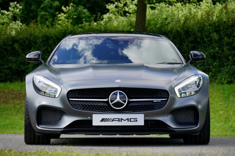 A silver Mercedes-AMG GT parked on a road.