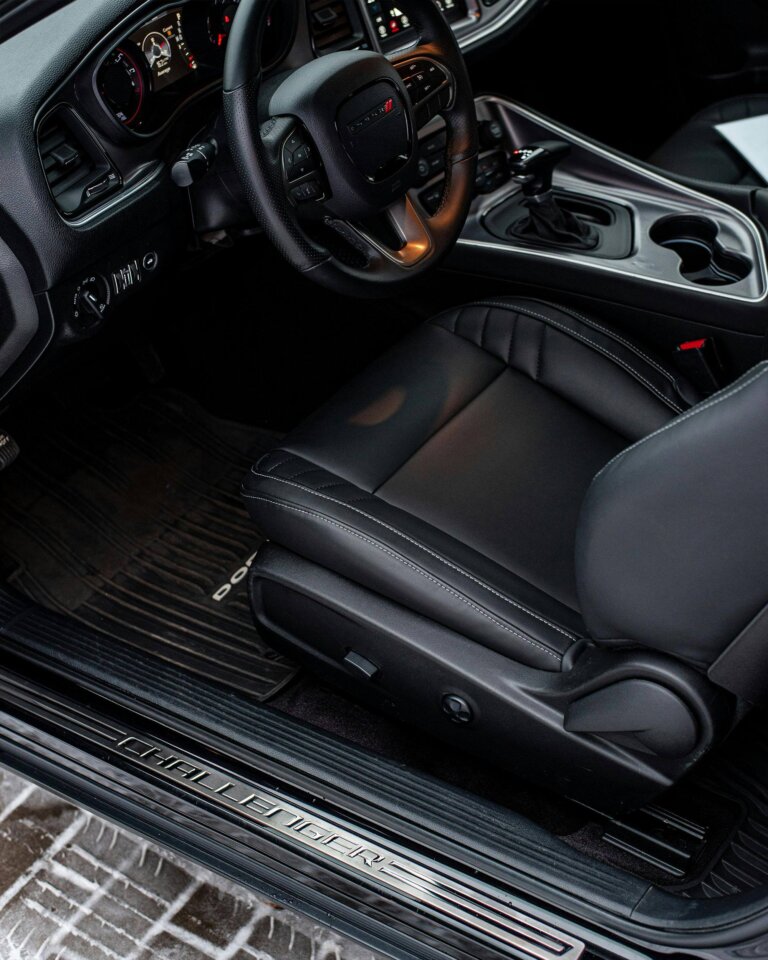 The driver's seat and dashboard of a Dodge Challenger.