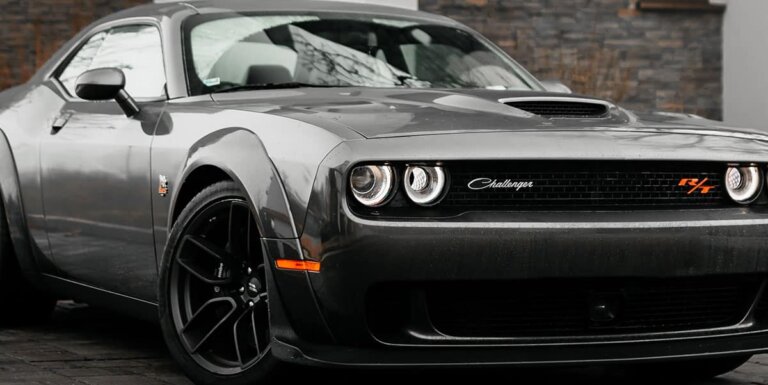 A gray Dodge Challenger parked outside.