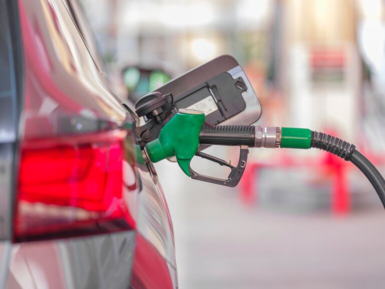 Fuel pump nozzle in a car filler neck at a gas station