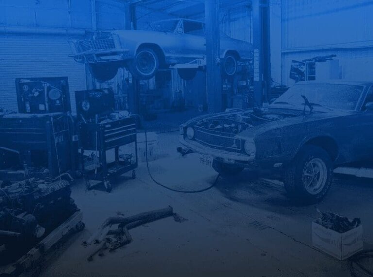 Two vehicles in a repair shop.